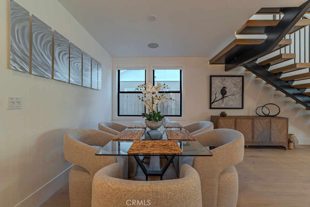 603 Acacia Avenue, Unit A Corona del Mar, CA 92625 - Photo 16 of 53 a dining room with furniture and wooden floor