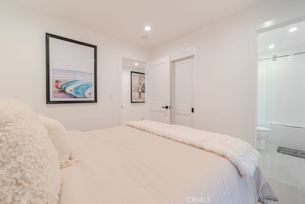 603 Acacia Avenue, Unit A Corona del Mar, CA 92625 - Photo 28 of 53 a bedroom with a large bed and a painting on the wall
