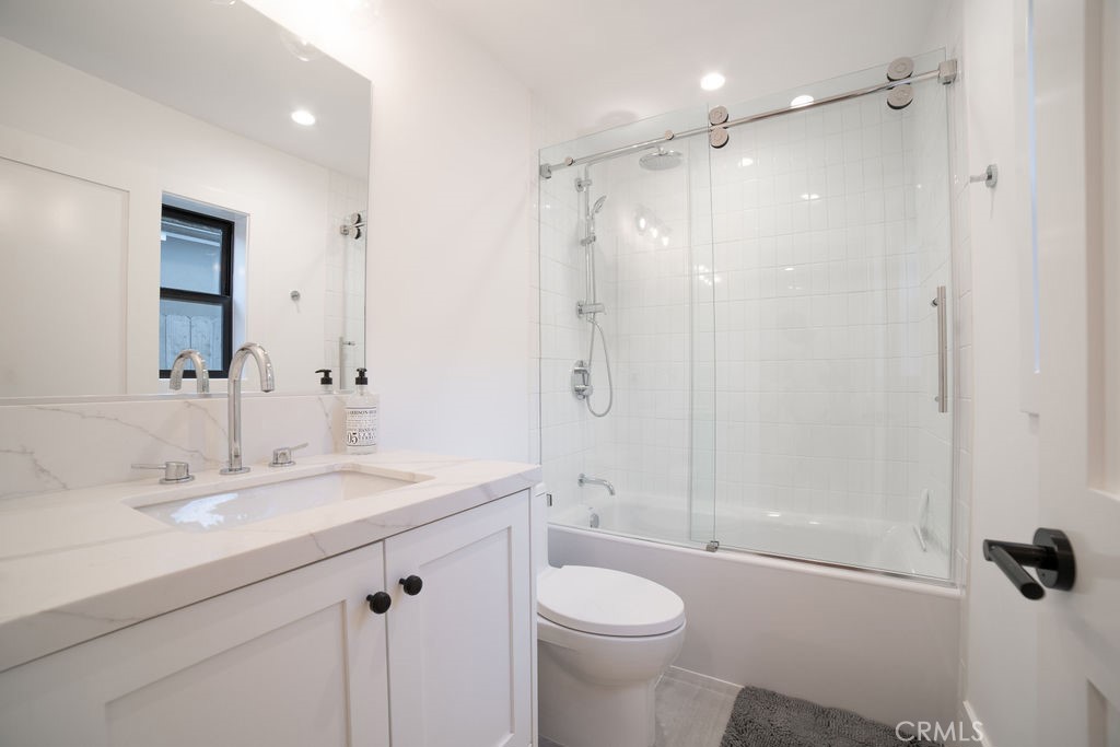 603 Acacia Avenue, Unit A Corona del Mar, CA 92625 - Photo 29 of 53 a bathroom with a sink a toilet a mirror and shower