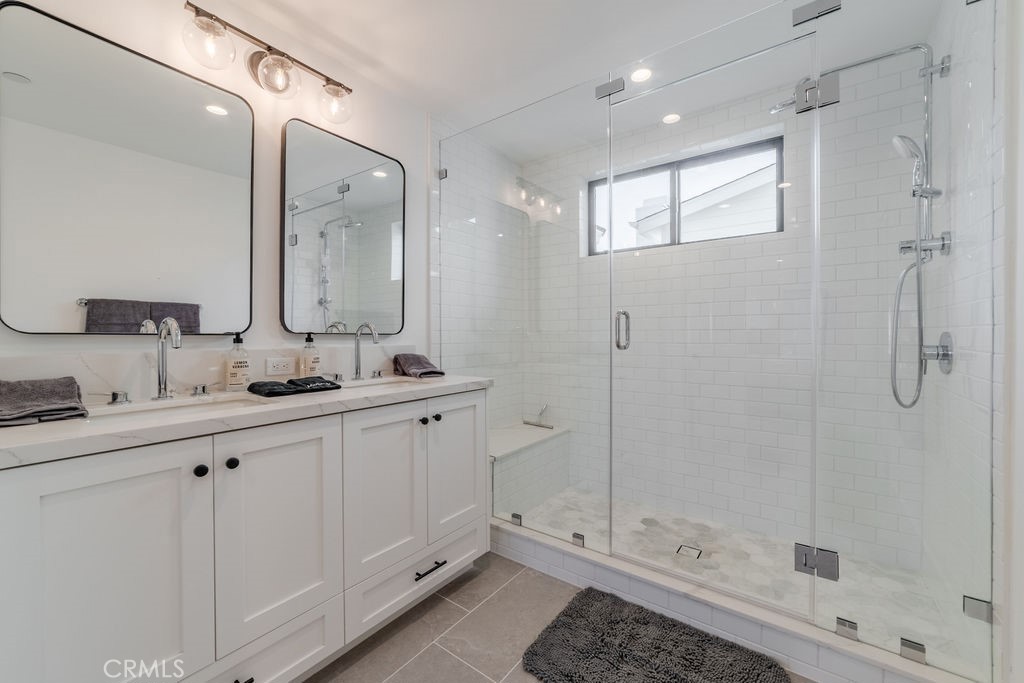 603 Acacia Avenue, Unit A Corona del Mar, CA 92625 - Photo 35 of 53 a bathroom with a shower sink and mirror