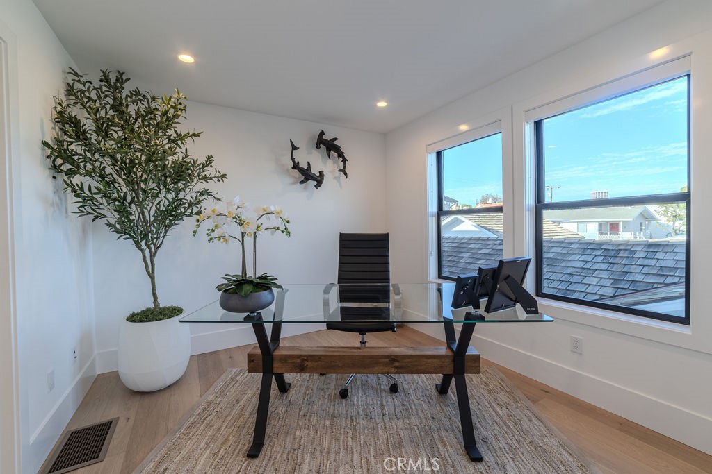 603 Acacia Avenue, Unit A Corona del Mar, CA 92625 - Photo 40 of 53 a living room with furniture a potted plant and a large window