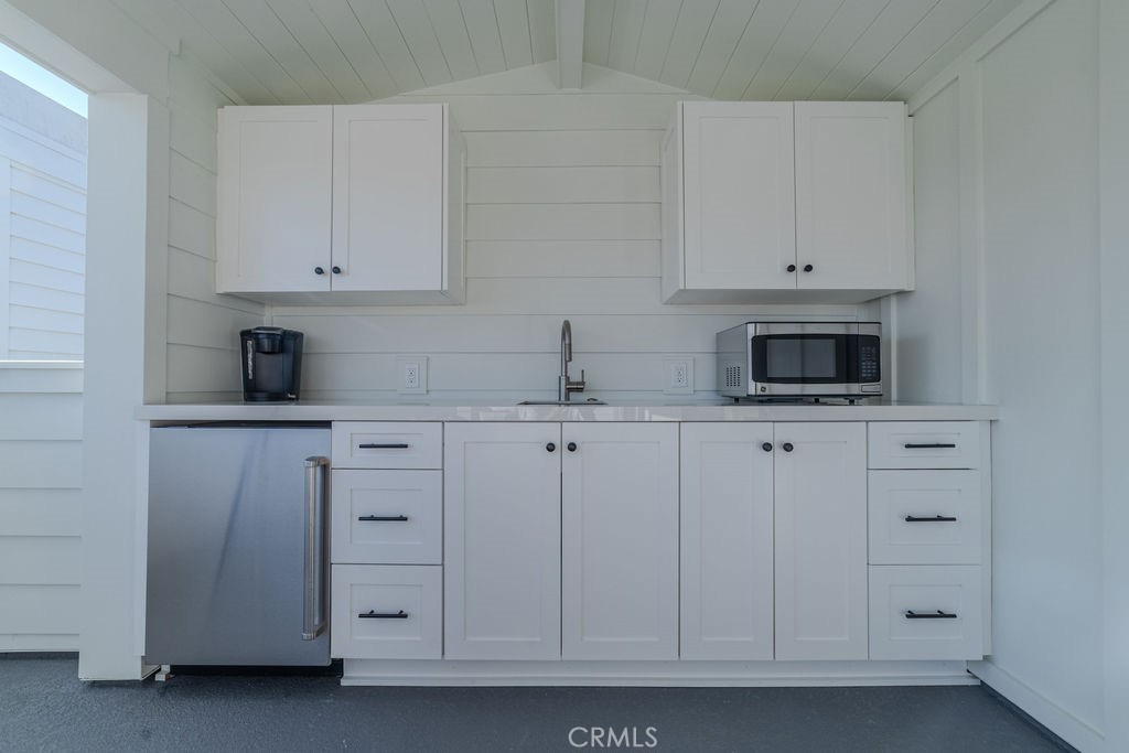 603 Acacia Avenue, Unit A Corona del Mar, CA 92625 - Photo 45 of 53 a kitchen with white cabinets and sink