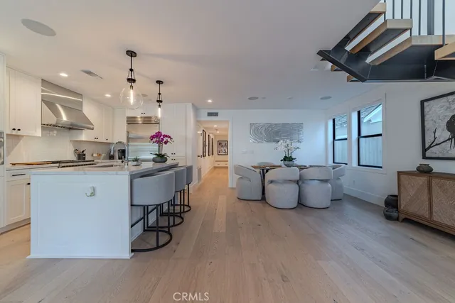 a living room with furniture and kitchen view