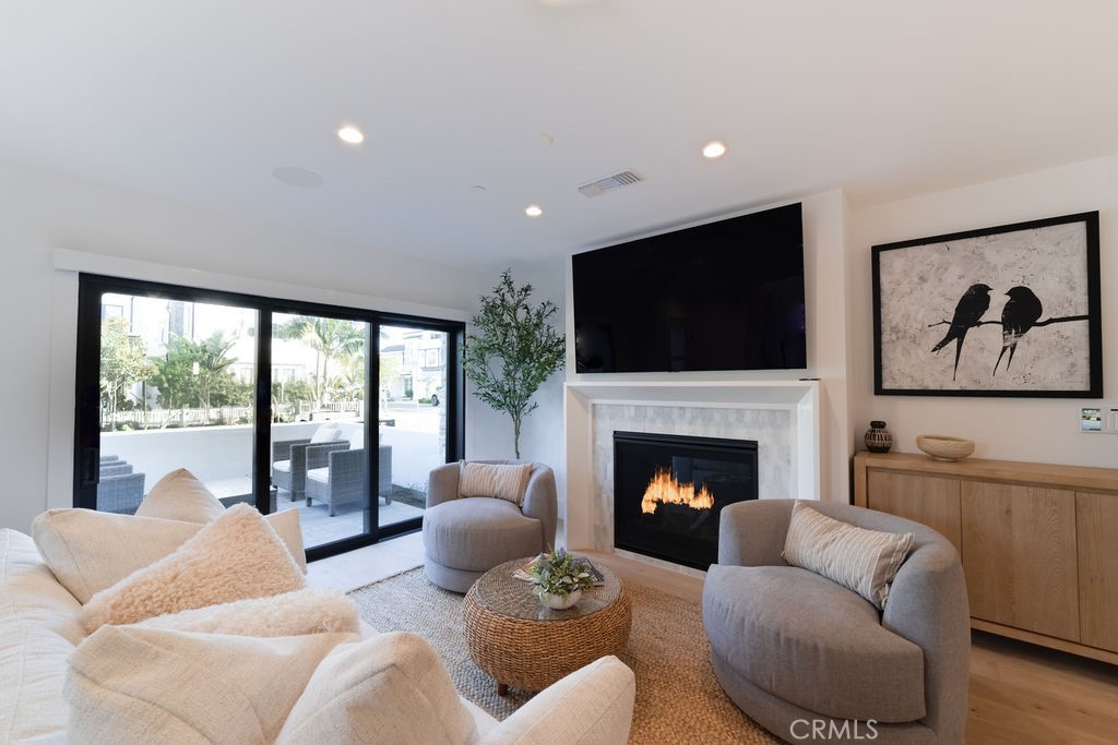 603 Acacia Avenue, Unit A Corona del Mar, CA 92625 - Photo 10 of 53 a living room with furniture fireplace and flat screen tv