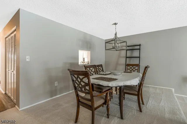 a view of a dining room with furniture and window