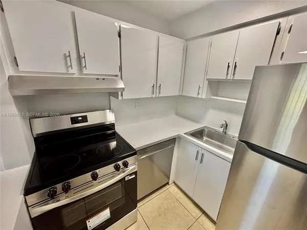 a stove top oven sitting inside of a kitchen