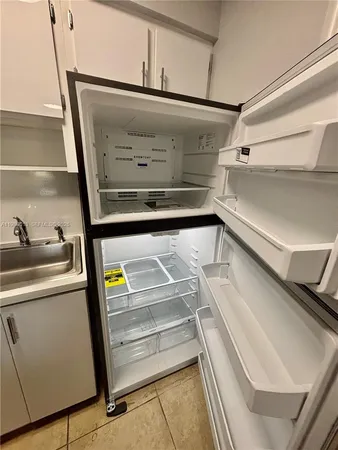 a stove top oven sitting inside of a kitchen