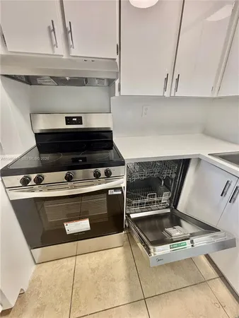 a kitchen with a sink and a stove top oven