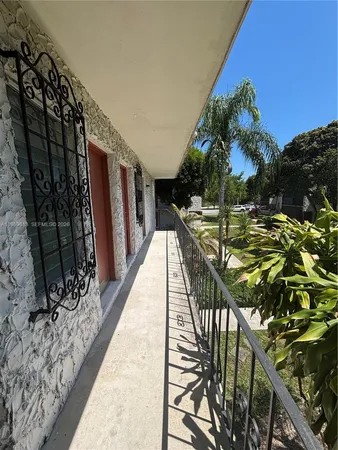 a view of balcony with wooden floor