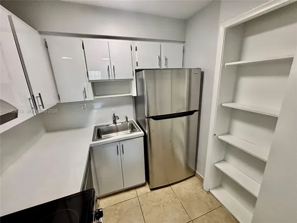 a stove top oven sitting inside of a kitchen