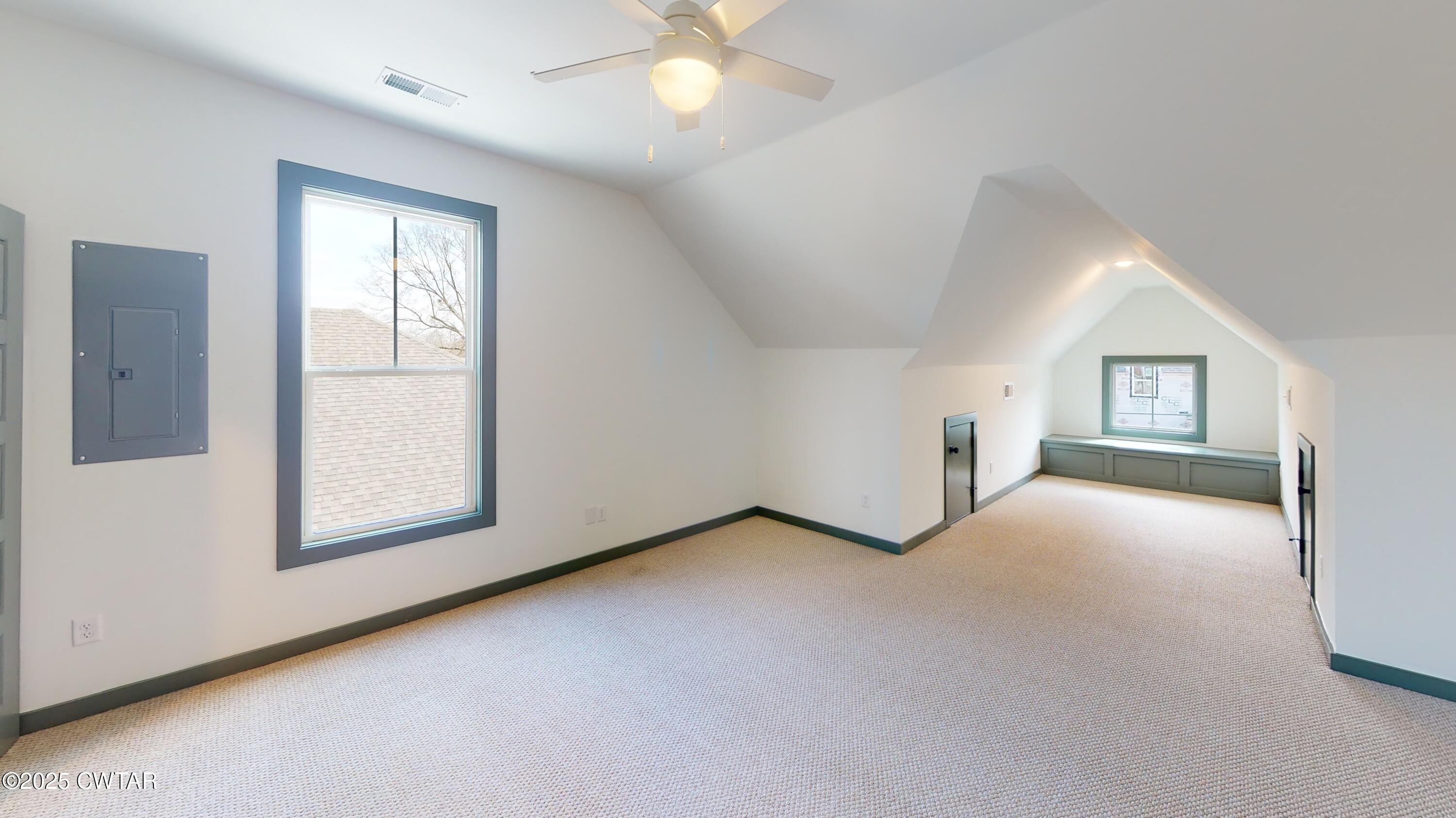 205 McCowat Street Jackson, TN 38301 - Photo 15 of 23 an empty room with windows and ceiling fan