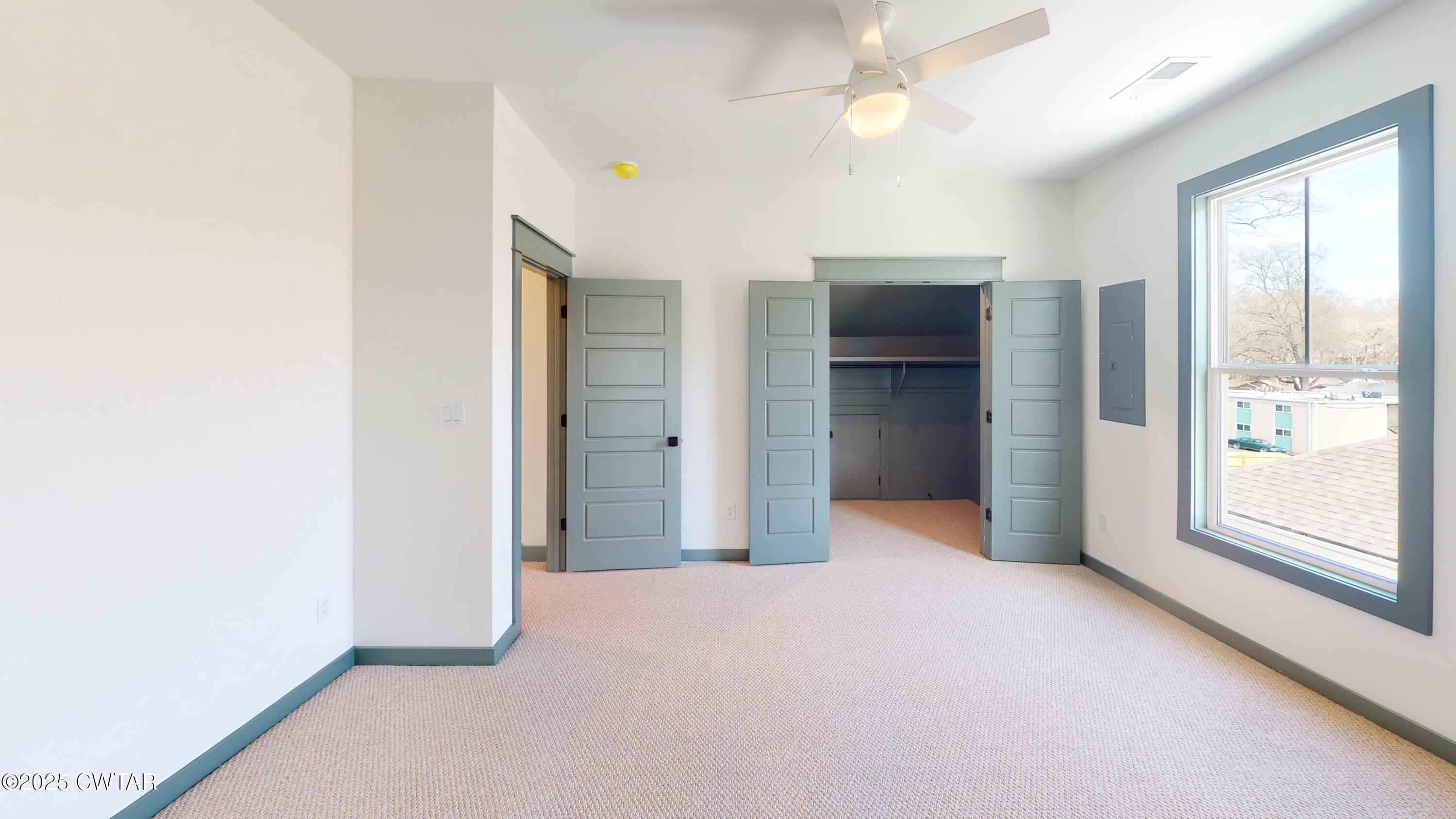 205 McCowat Street Jackson, TN 38301 - Photo 16 of 23 an empty room with windows and closet