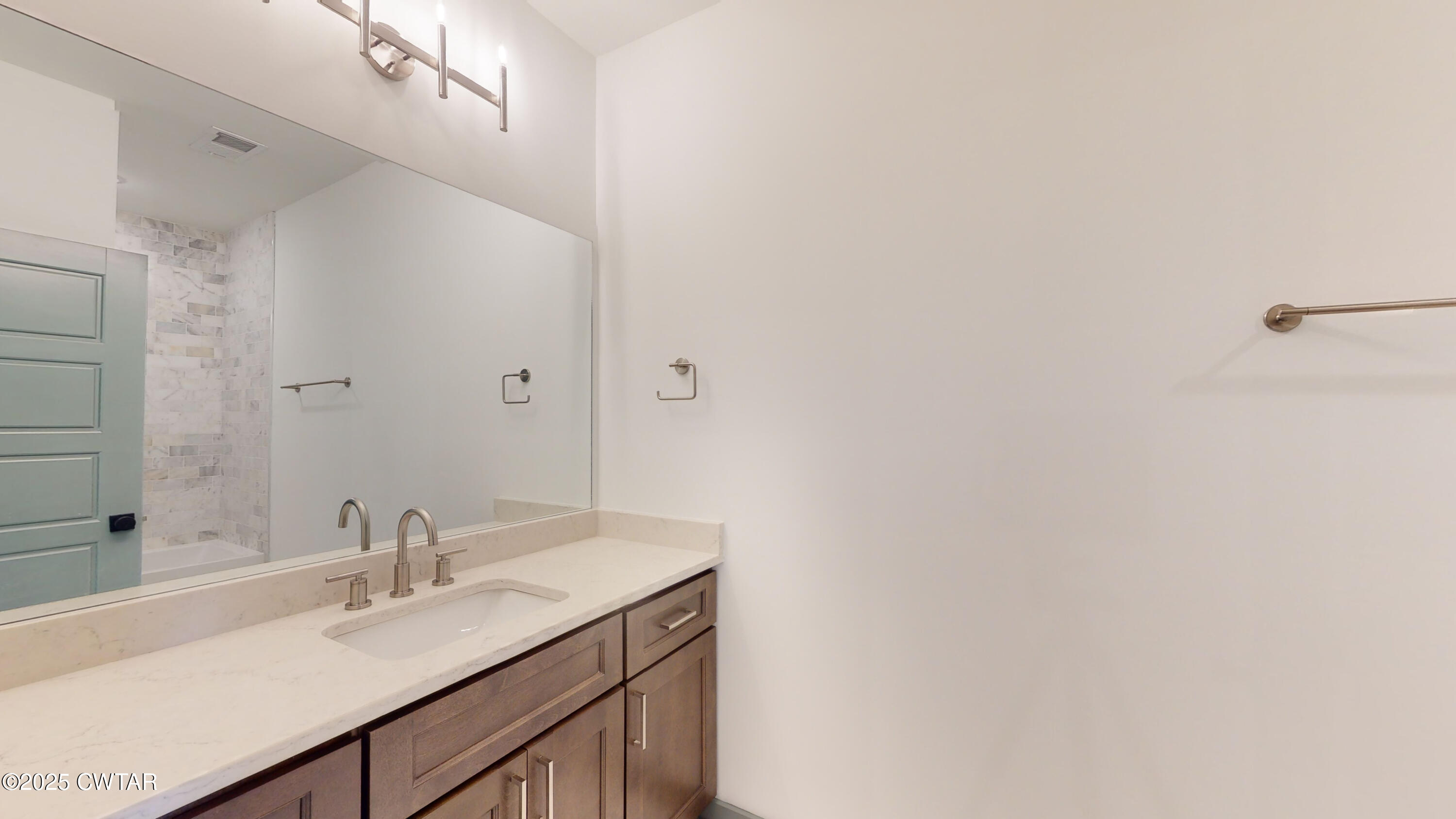 205 McCowat Street Jackson, TN 38301 - Photo 17 of 23 a bathroom with a sink and a mirror