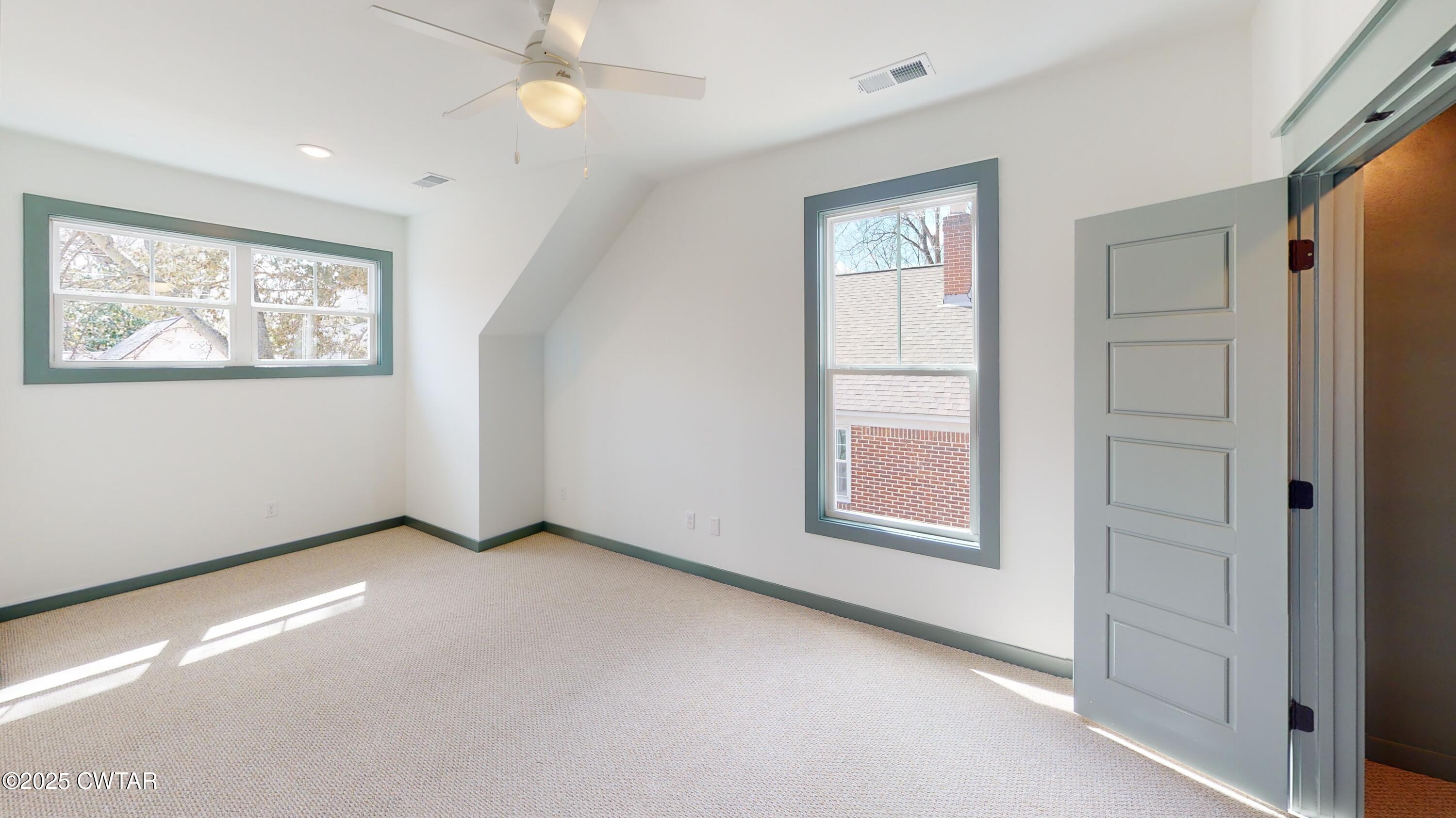 205 McCowat Street Jackson, TN 38301 - Photo 19 of 23 an empty room with windows and closet