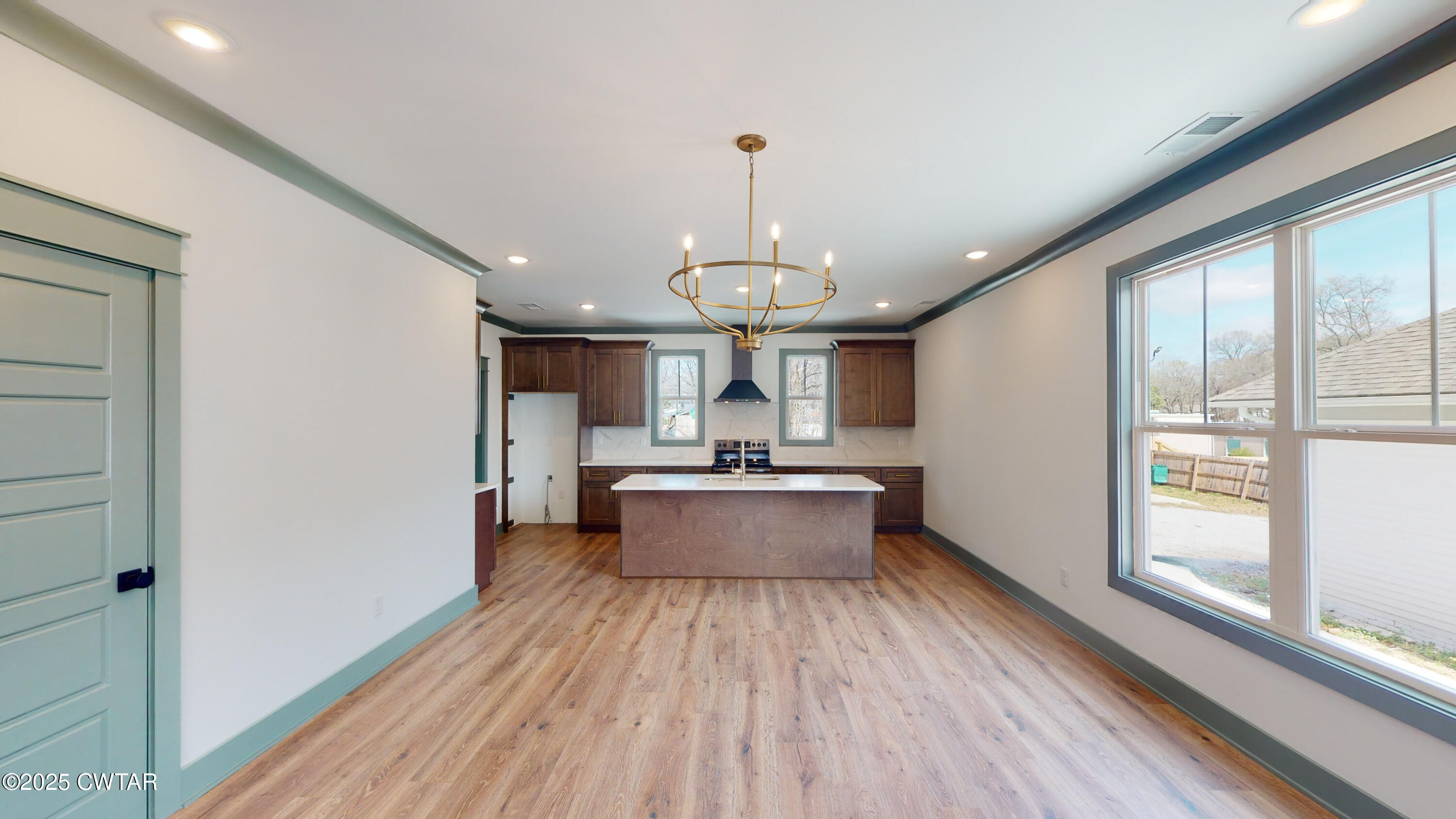 205 McCowat Street Jackson, TN 38301 - Photo 3 of 23 a large room with wooden floor and large windows