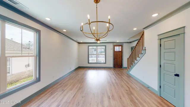 a view of entryway with wooden floor and window