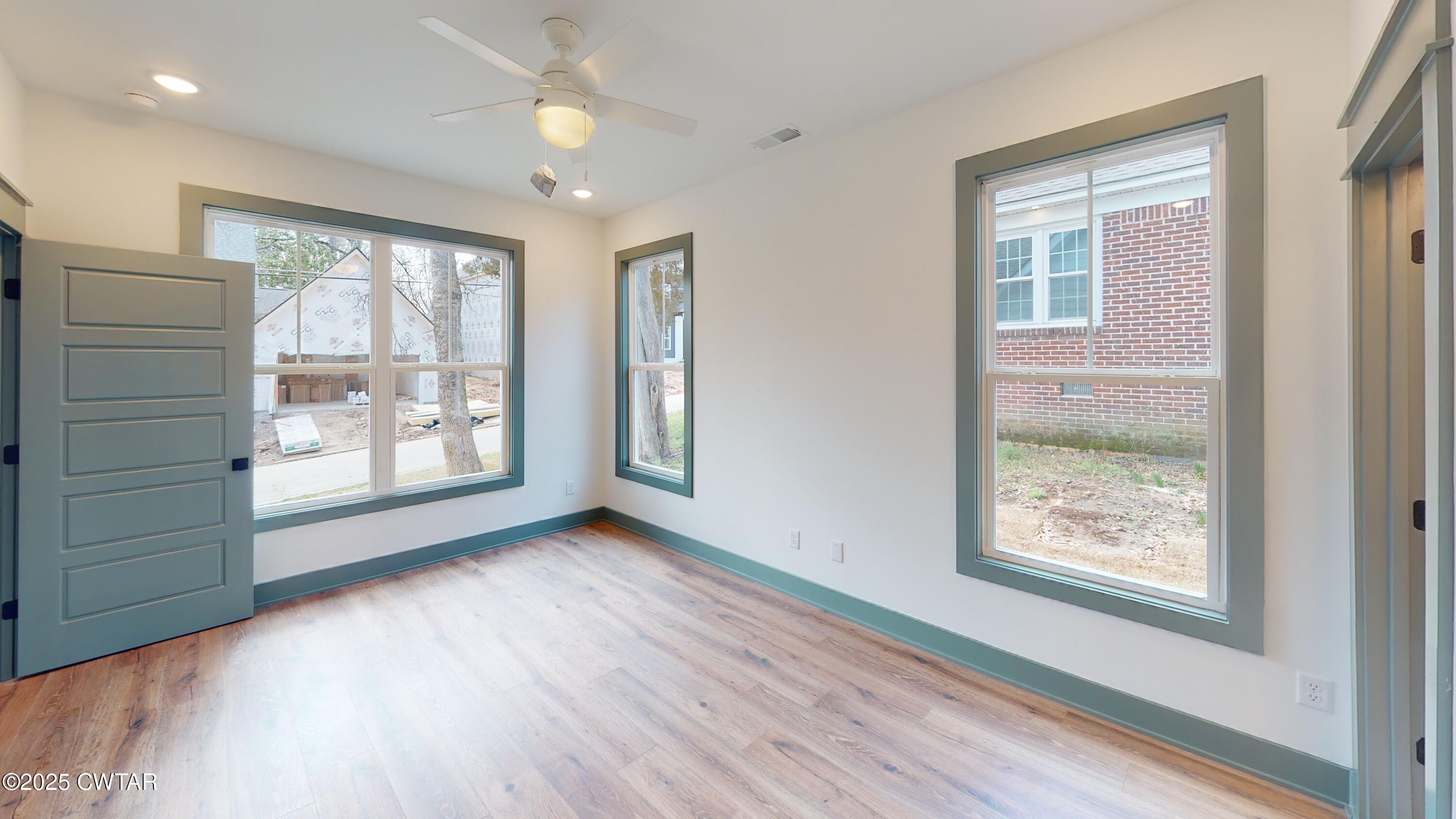 205 McCowat Street Jackson, TN 38301 - Photo 10 of 23 a view of an empty room with a window and wooden floor