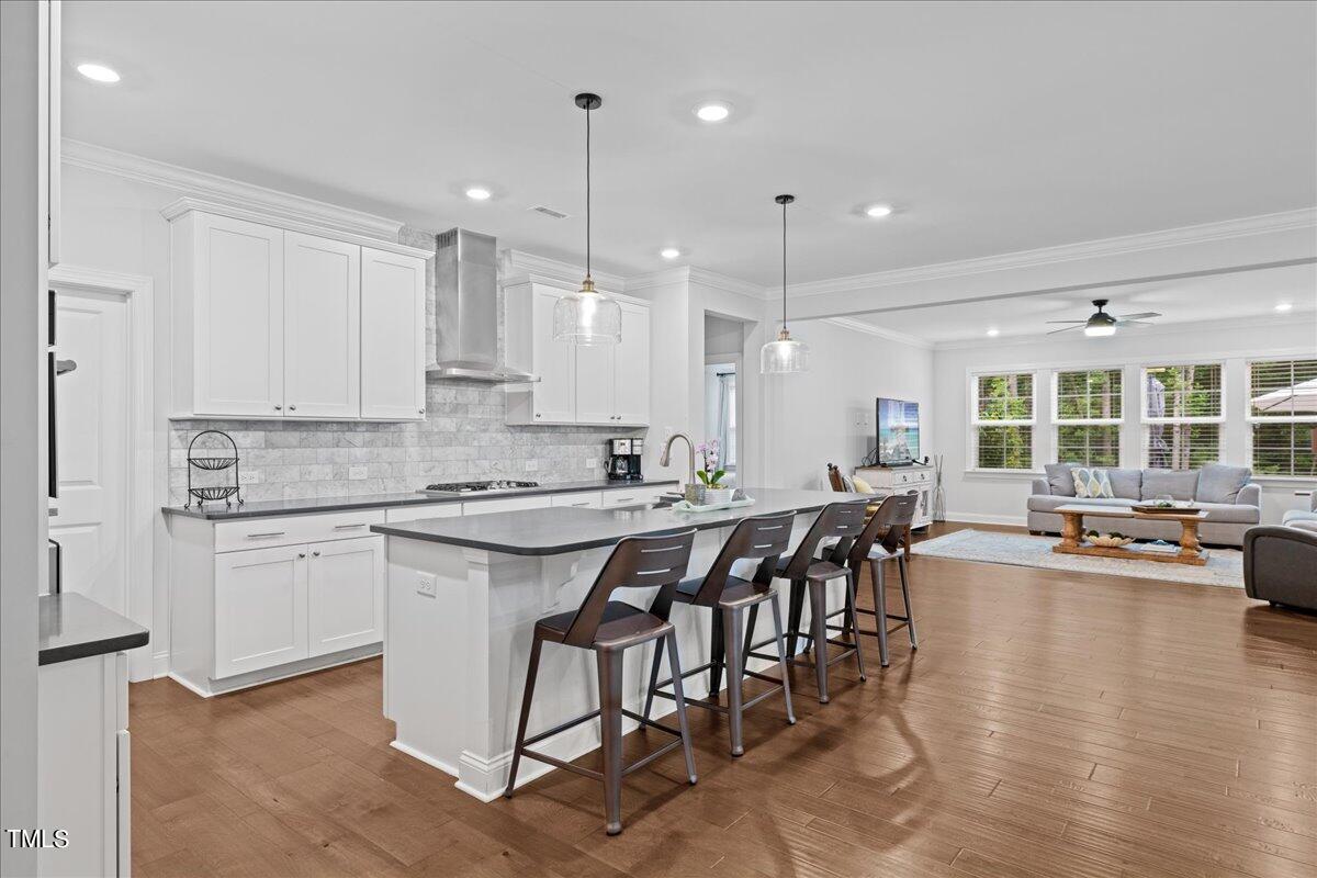 229 Ivory Lane Raleigh, NC 27610 - Photo 8 of 46 a kitchen with a dining table chairs stove and white cabinets