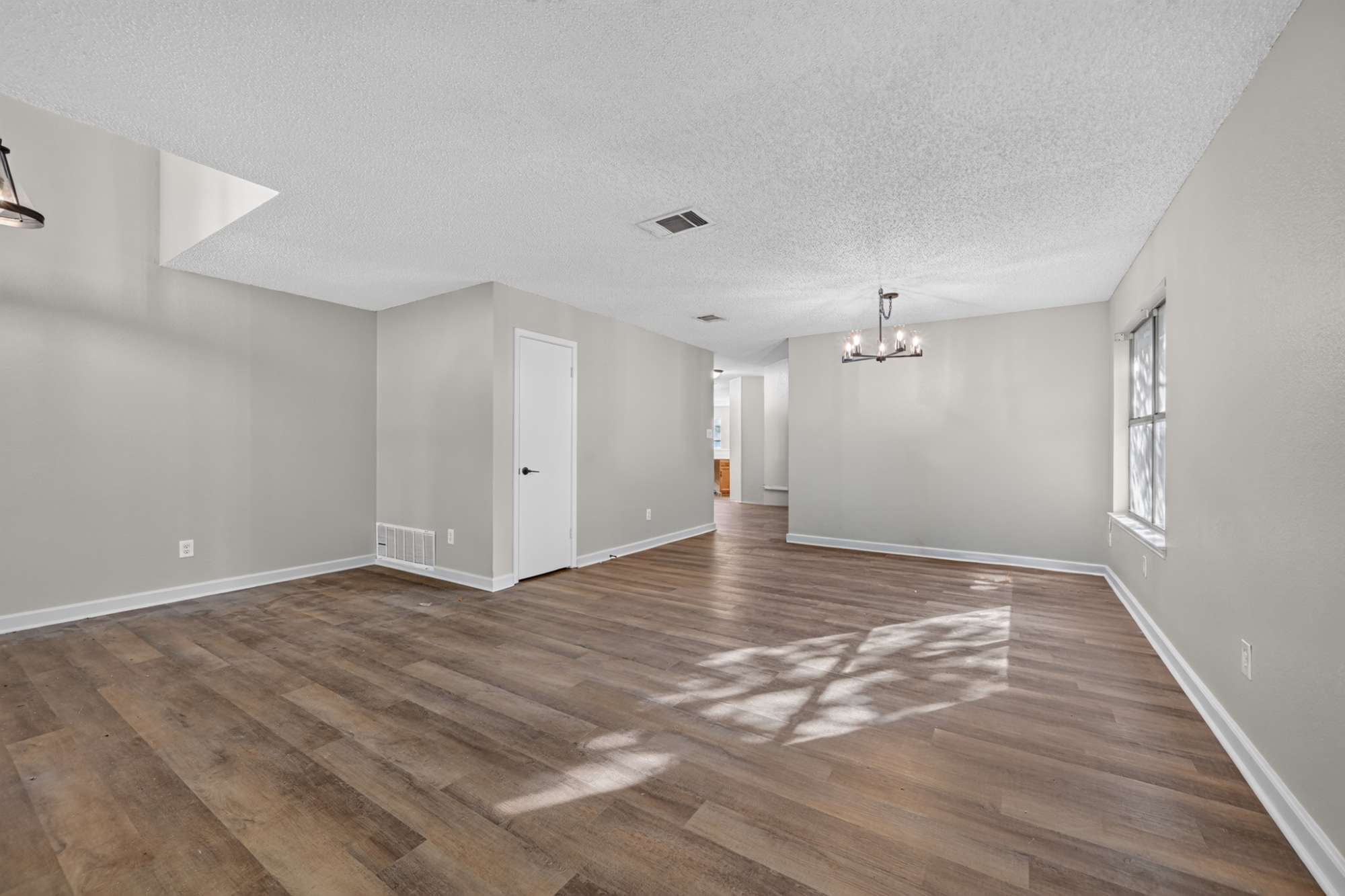 904 Nelson Ranch Road Cedar Park, TX 78613 - Photo 6 of 21 Warm wood-look flooring sets an inviting tone across this open and airy living area.