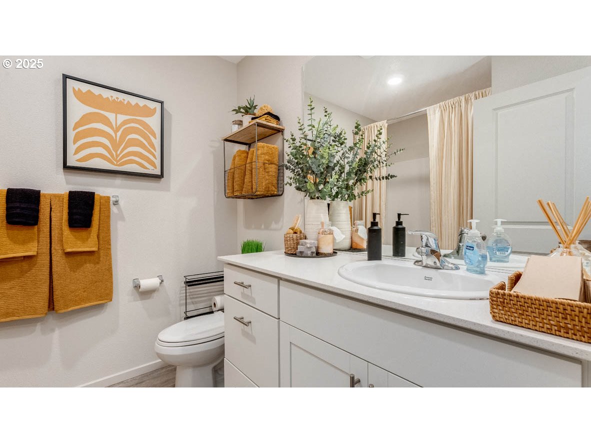 238 Greencrest Street Northeast Salem, OR 97301 - Photo 5 of 26 a bathroom with a toilet sink and mirror