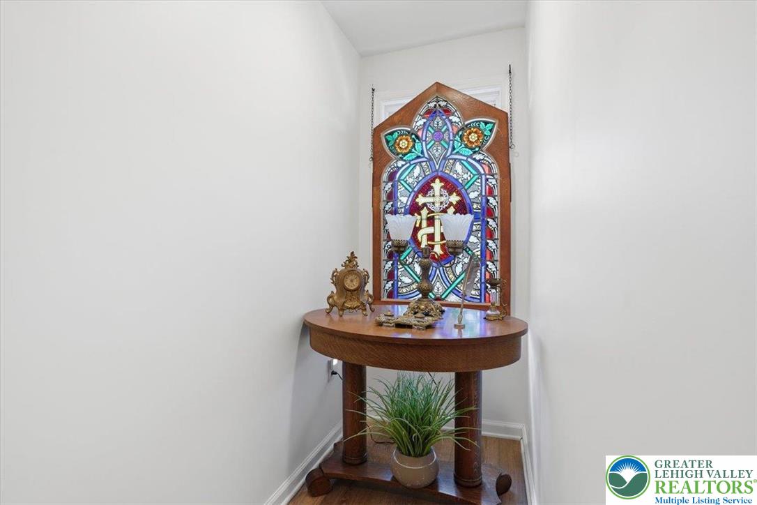 4880 Little Gap Road Kunkletown, PA 18058 - Photo 13 of 100 This entry nook features rich hardwood flooring and a distinct stained-glass window accent.