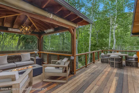 a view of house with deck and outdoor seating