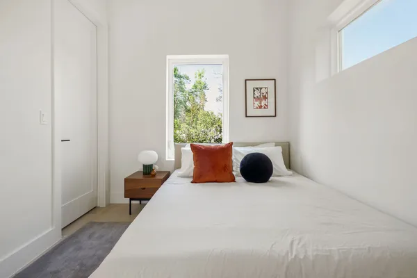 a bedroom with a bed and a window