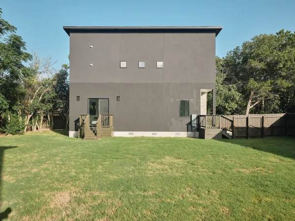 a backyard of a house with table and chairs
