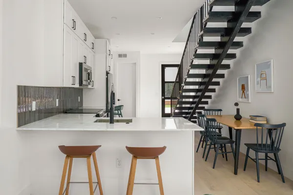 a dining room with furniture and wooden floor