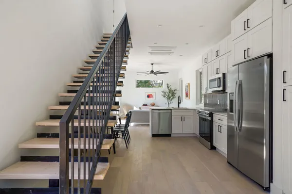 a kitchen with stainless steel appliances a refrigerator sink and stove