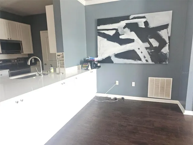 a kitchen with a refrigerator and a stove