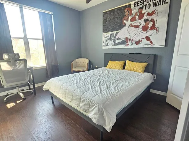 a bed sitting in a bedroom next to a window