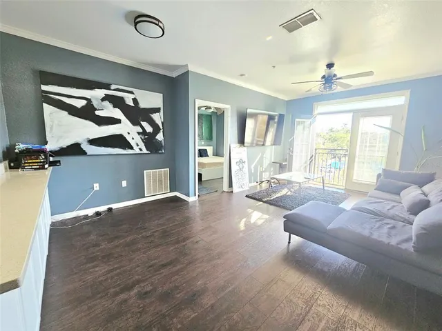 a living room with kitchen island furniture and a wooden floor