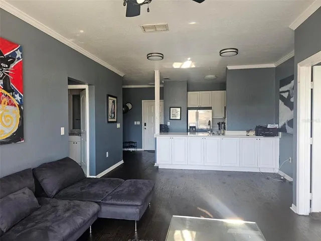 a living room with furniture and wooden floor