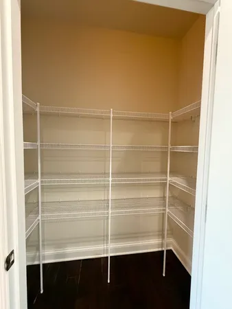 a view of walk in closet with empty racks