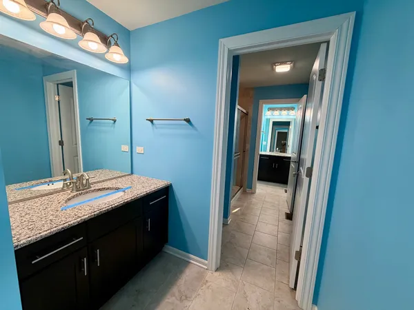an empty room with windows and ceiling fan