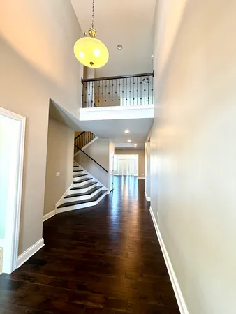 a view of entryway and hall with wooden floor