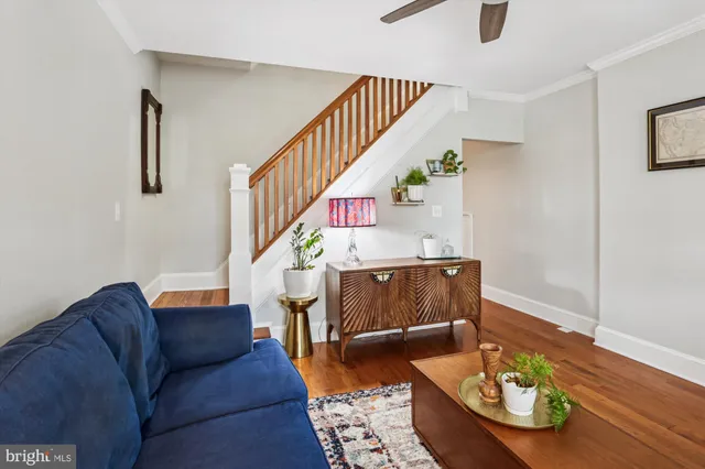 a dining room with furniture a chandelier and wooden floor