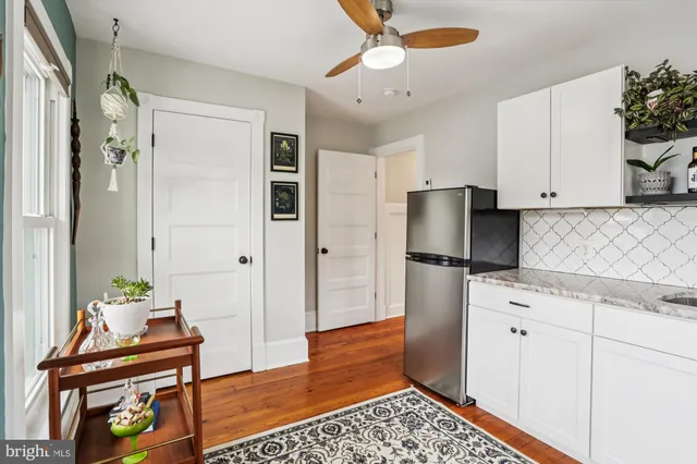 a view of a white house with a yard and garage