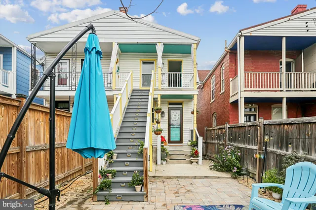 a front view of a house with glass windows and stairs