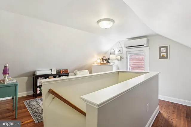 a city street lined with parked cars and buildings