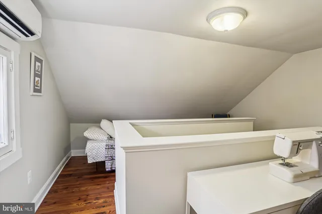 a view of a lake with beach and large trees