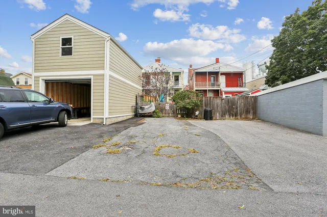 front view of a brick house next to a yard