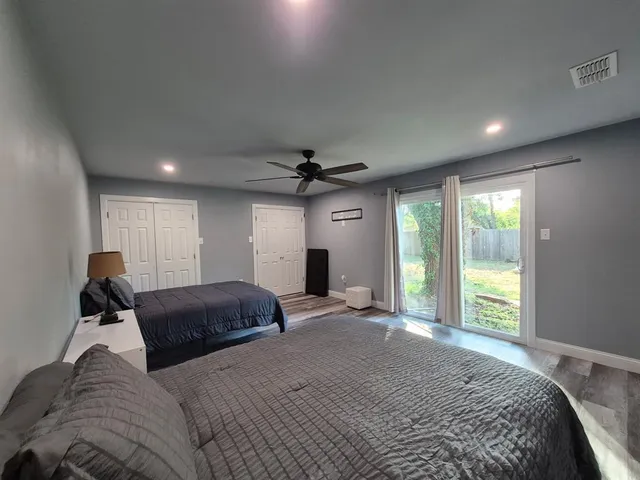 a bedroom with a large bed and a window