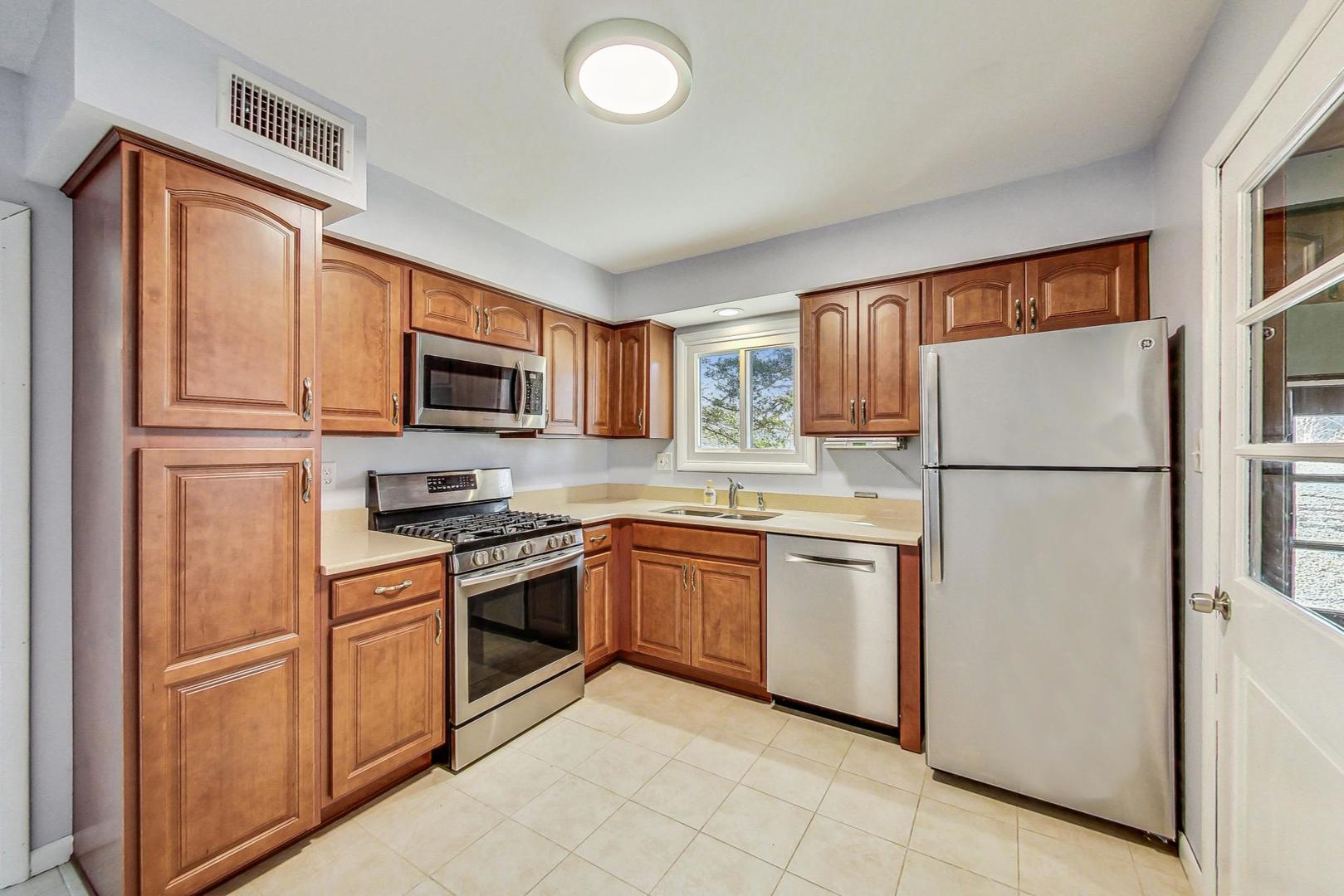 10S462 Ruth Drive Lemont, IL 60439 - Photo 7 of 24 a kitchen with stainless steel appliances granite countertop a refrigerator stove a sink dishwasher and microwave