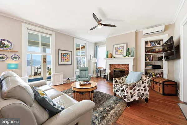 a bedroom with a bed lamp and a large window