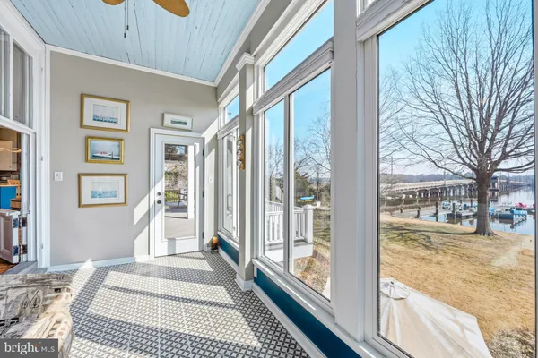 a view of a livingroom with wooden floor and a fireplace