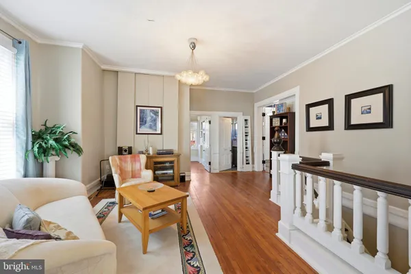 a view of a porch with furniture and wooden floor