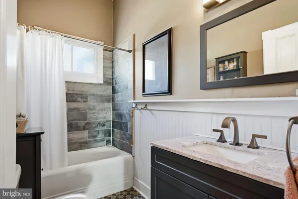 a kitchen with stainless steel appliances granite countertop a refrigerator a stove and a sink with wooden floor