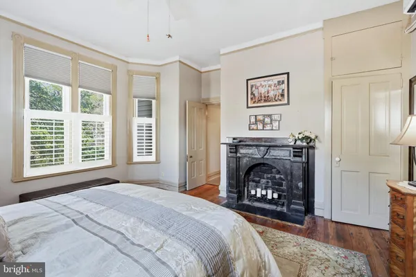 a view of hallway with stairs and wooden floor